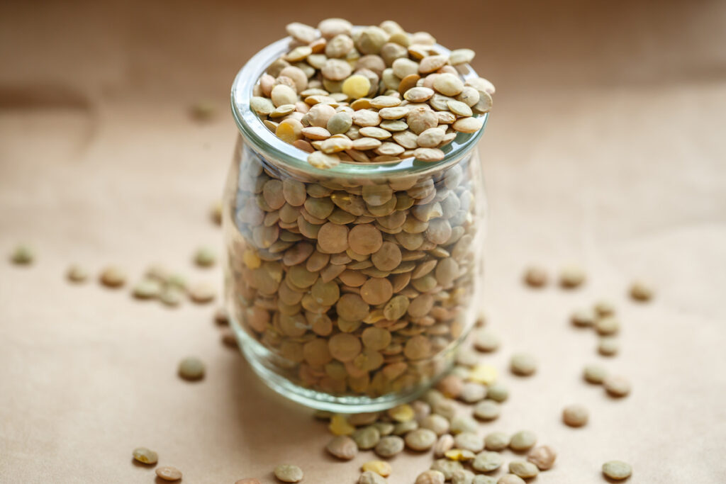 lentils in a small glass jar on top of a table