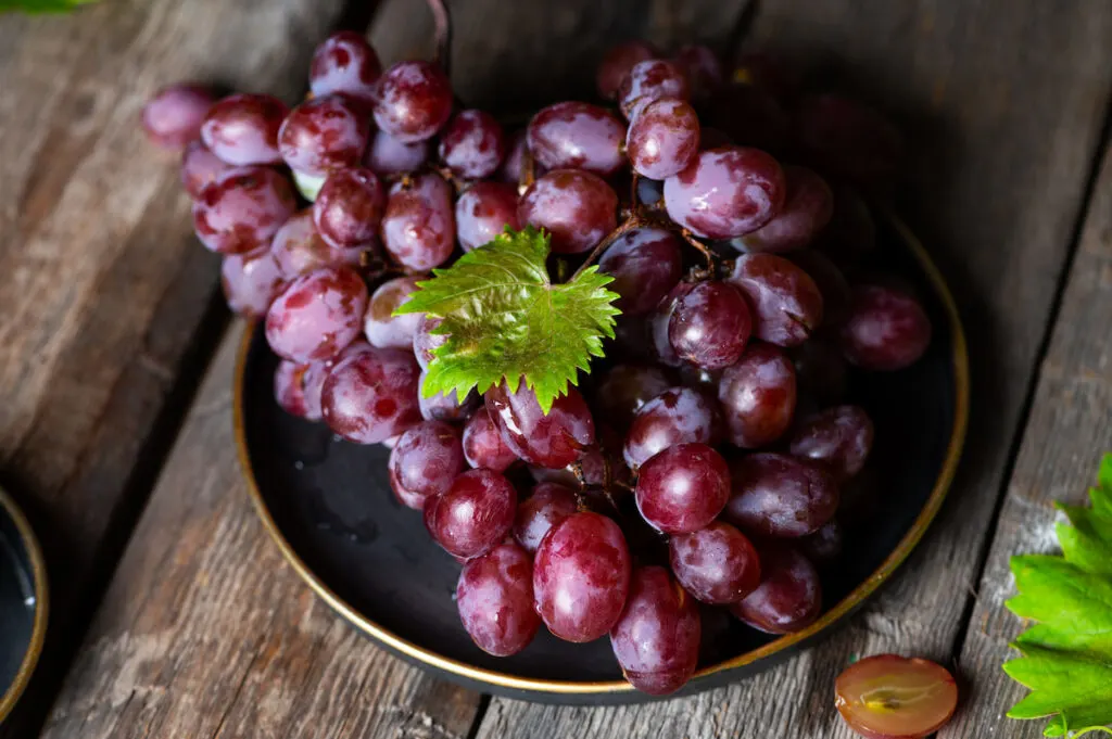 purple ripe grapes on a plate