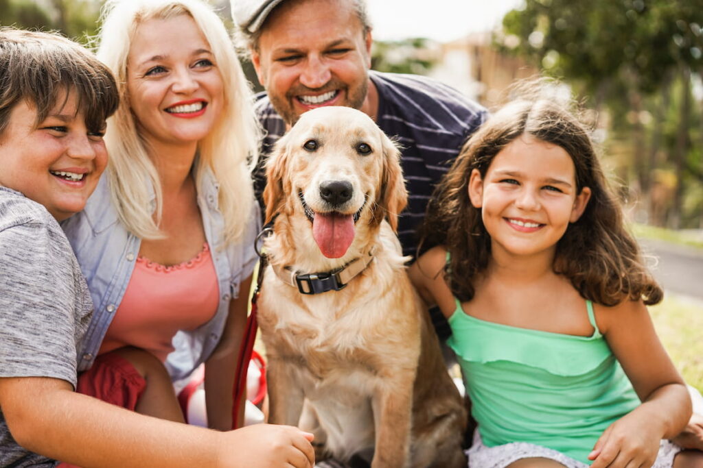 family having fun with children and their dog 